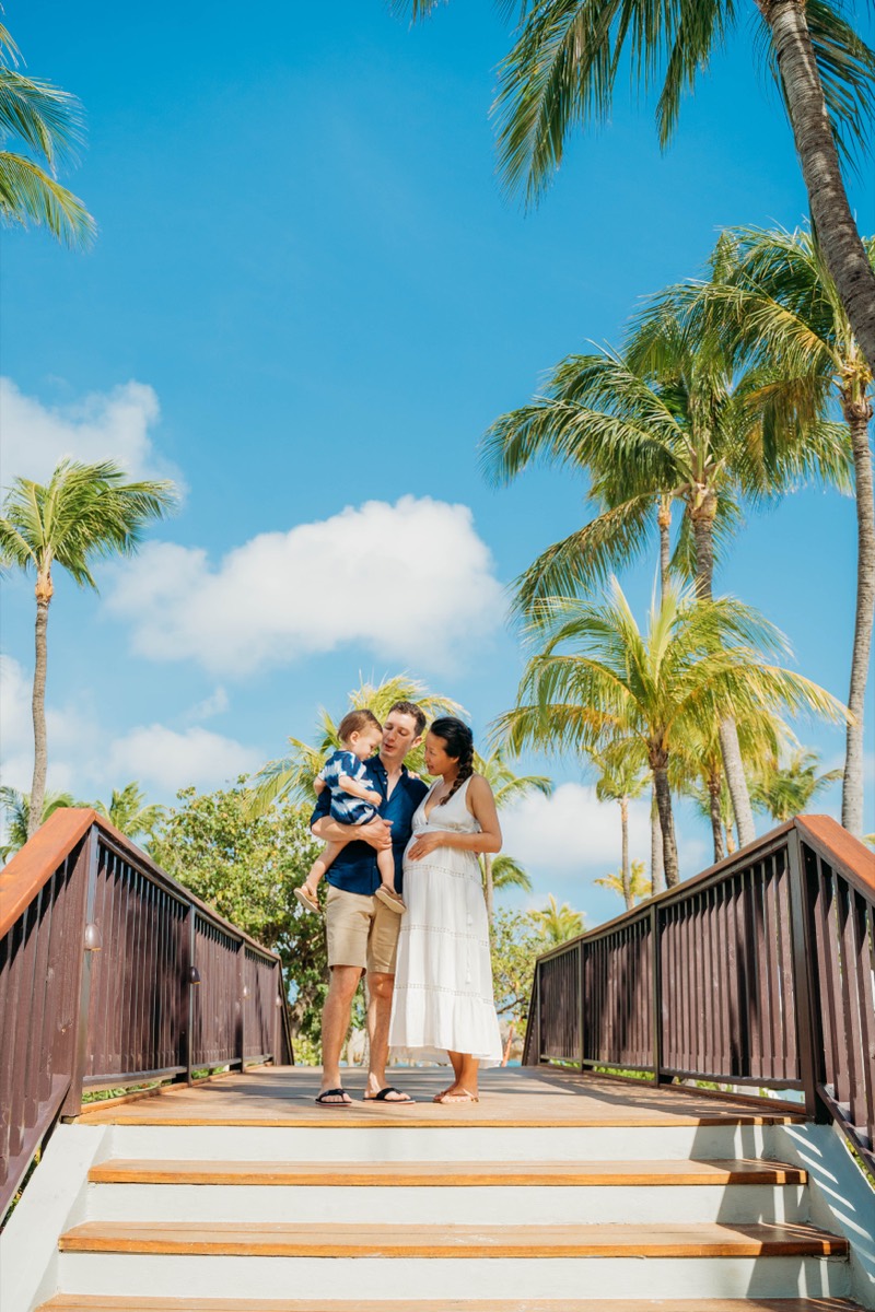 Family on a palm-lined pier, Aruba