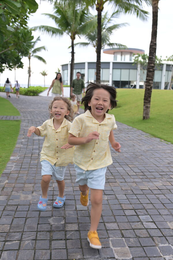 Kids running the palm-lined path, Da Nang