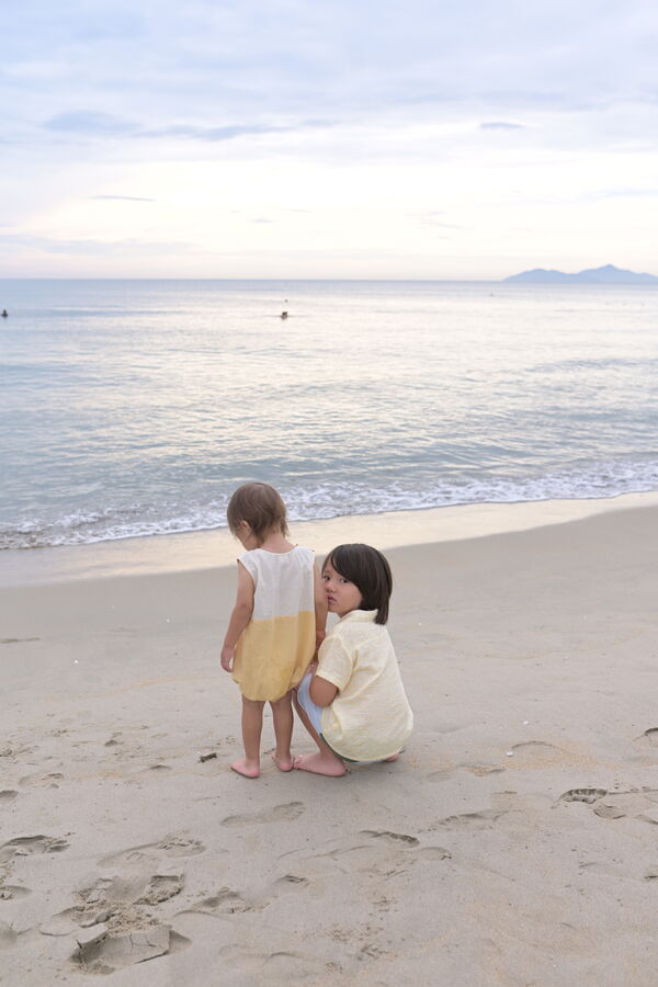 Two kids on the beach at dusk, Da Nang