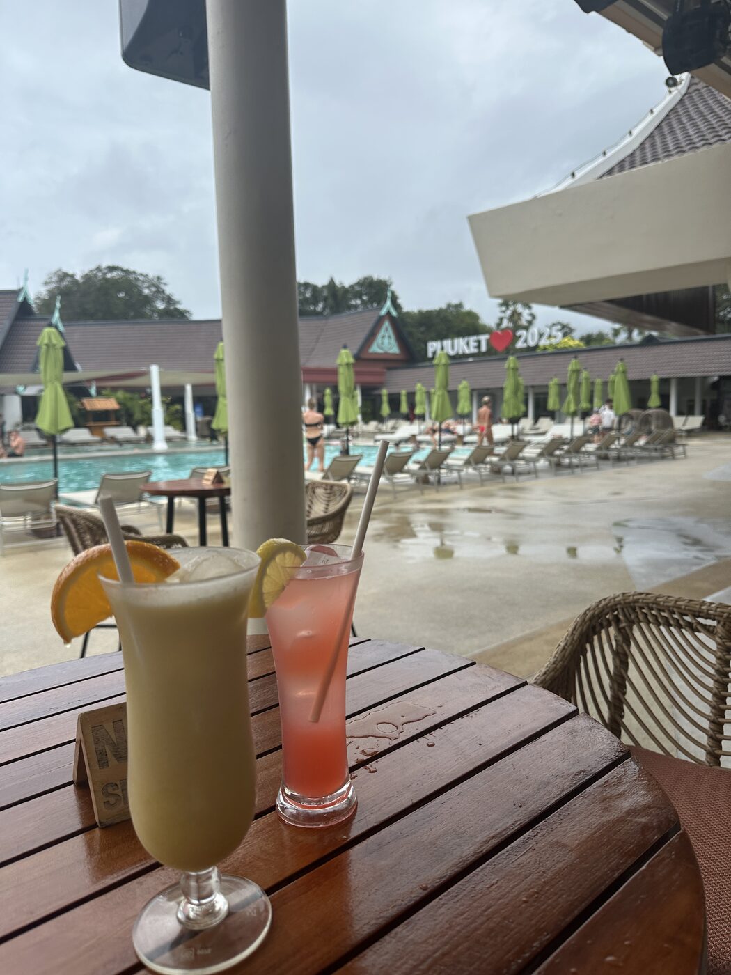 The moms clinking glasses by the adults-only pool